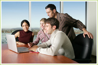 photo group leaning over laptop